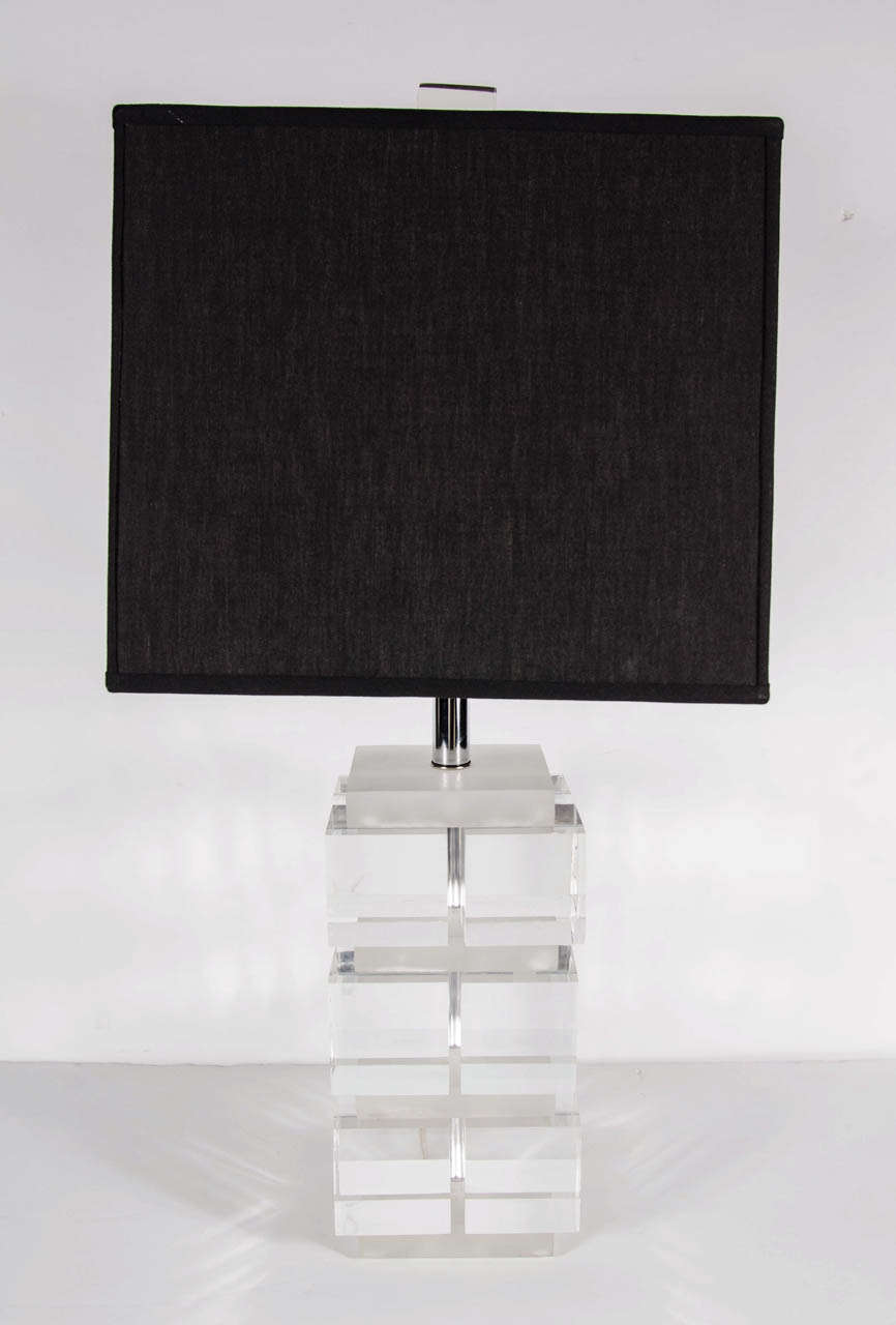 This lamp features three tiers of translucent Lucite cubes- six per side- with inset channels in frosted Lucite and polished nickel fittings. The lamp comes fitted with its rectangular cube finial. The lamp comes fitted with two Edison based sockets