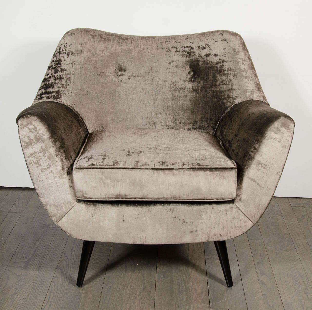 This outstanding Mid-Century Modernist Chair consists of an organic design, splayed conical legs in ebonized walnut and dual button back detail. Newly upholstered in lux grey velvet. Restored to mint condition.