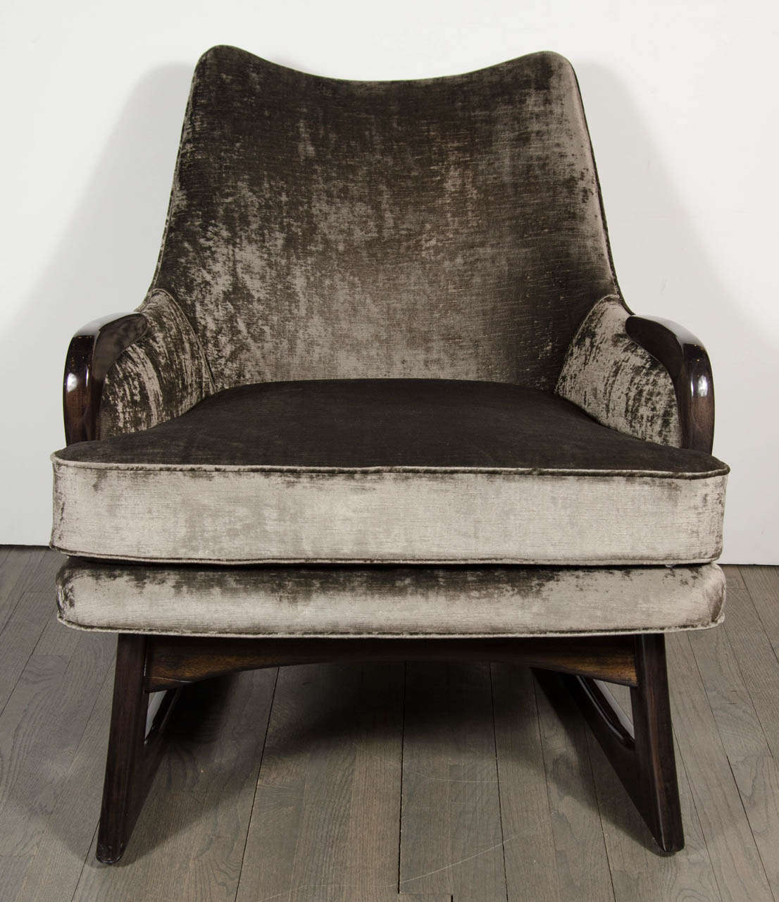 This very sophisticated sleigh form design Mid-Century armchair features ebonized walnut detailing and smoked pewter velvet upholstery. It has been mint restored and newly reupholstered.

Dimensions: 31.5