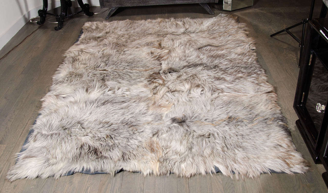 This Kidassia long hair goat skin rug is in all tones of treys,silvers and neutrals.
