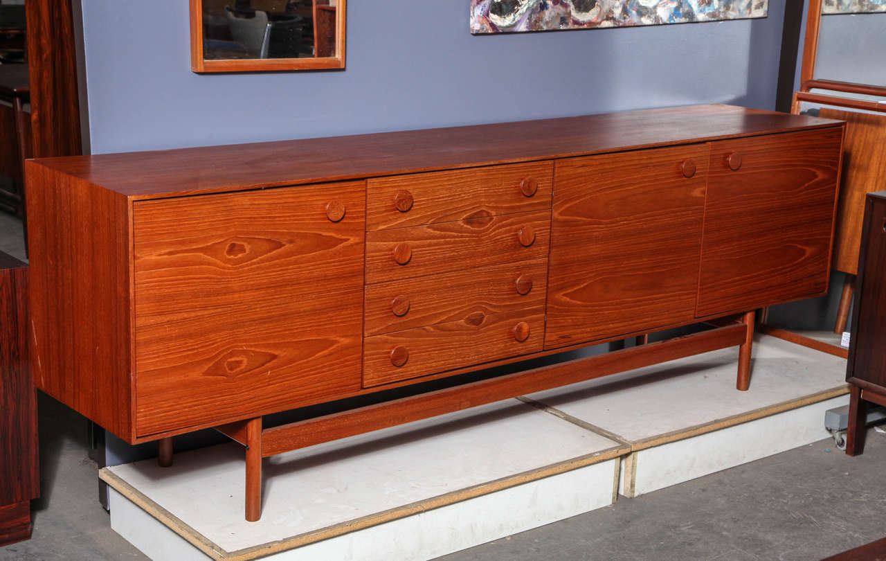 Vintage 1960s Danish Credenza by Ib Kofod Larsen

This Vintage Sideboard by Ib Kofod Larsen features three swinging doors and four shallow drawers perfect for storage of anything from linens to fine china. The round pulls are an interesting find