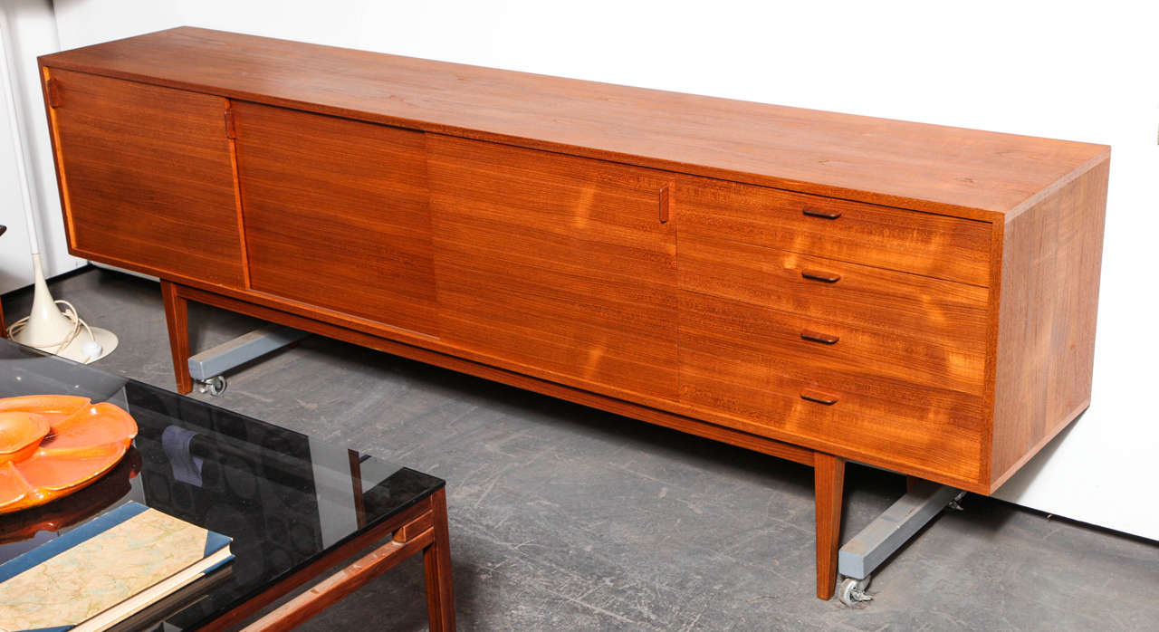 Very long Danish Teak Sideboard from the 1960s. The handles are reminiscent of Wegner's designs for Ry Mobler.  Excellent condition.