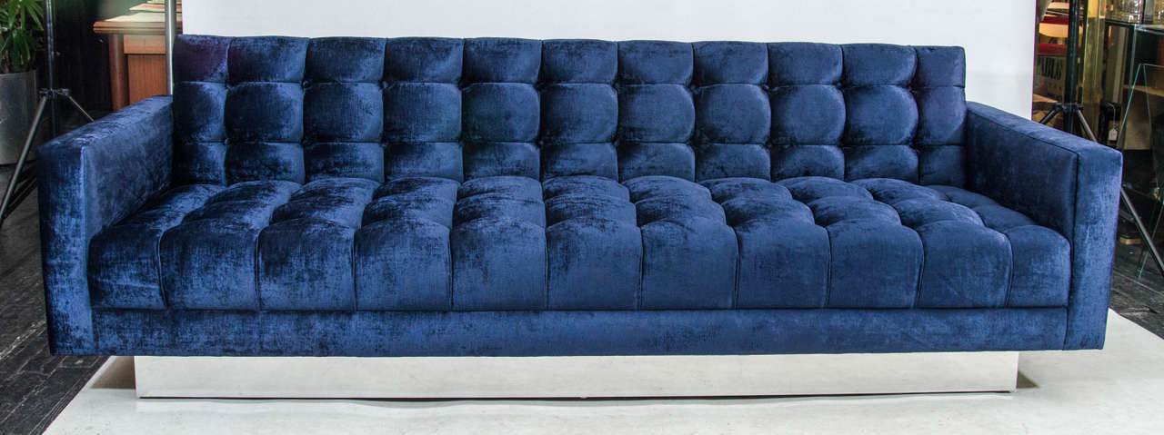 Stunning sofa with deep, plush tufting in a dark blue velvet. The sofa 
