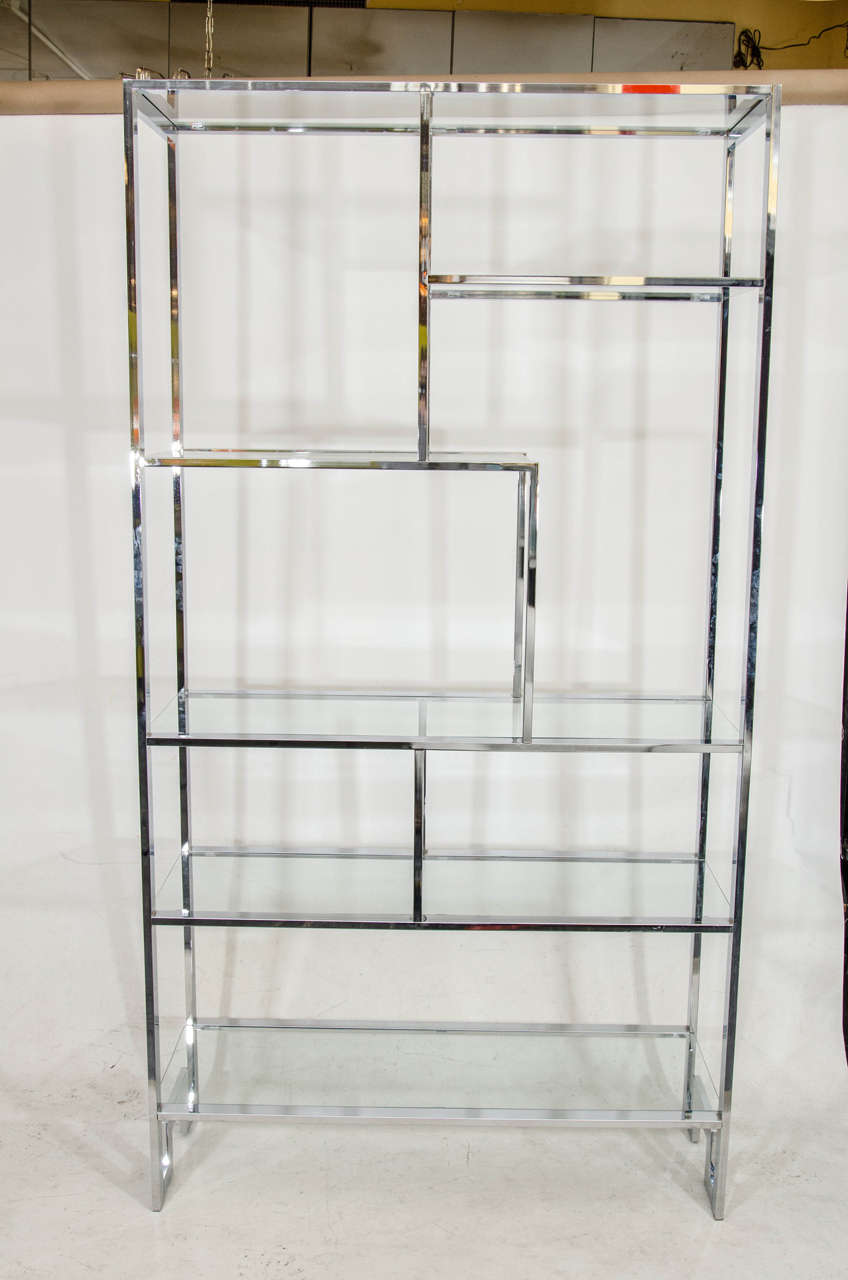 Beautiful chrome and glass etagere with an Mondrian style arrangement of upper shelves and 1/2 a greek key on the base. Please contact for location. Offered by Las Venus by Kenneth Clark, New York City.