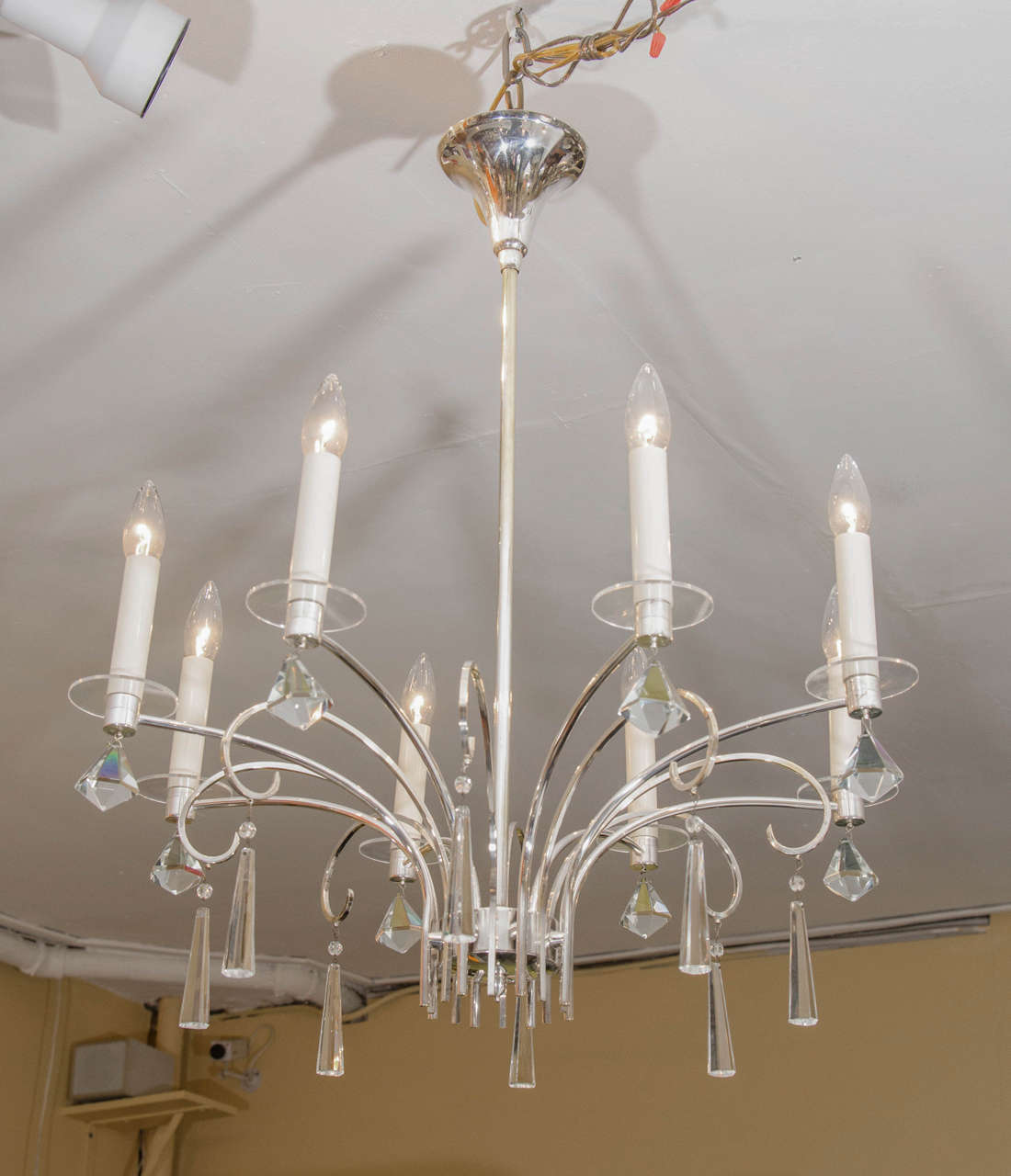 Lovely chandelier with a graceful armature. The piece is adorned with beautiful faceted, sparkly, modernist crystals. Lucite discs support the candelabras. Please contact for location. 