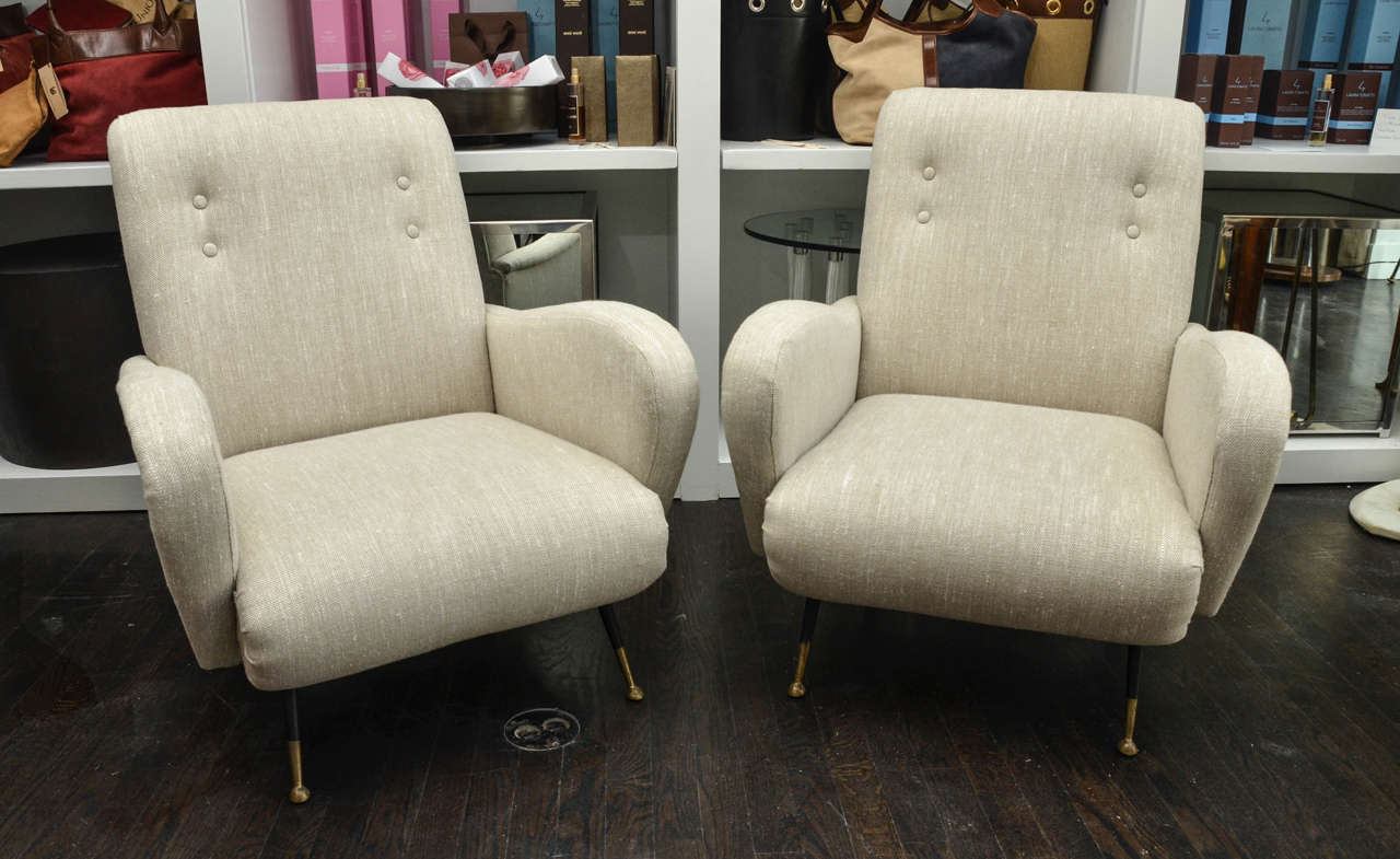 Simple and elegant lines give this pair of Mid-Century Italian chairs their distinctive modern look. With tight seats and decorative tufting along with the sculpted arms these unique chairs are the epitome of chic.