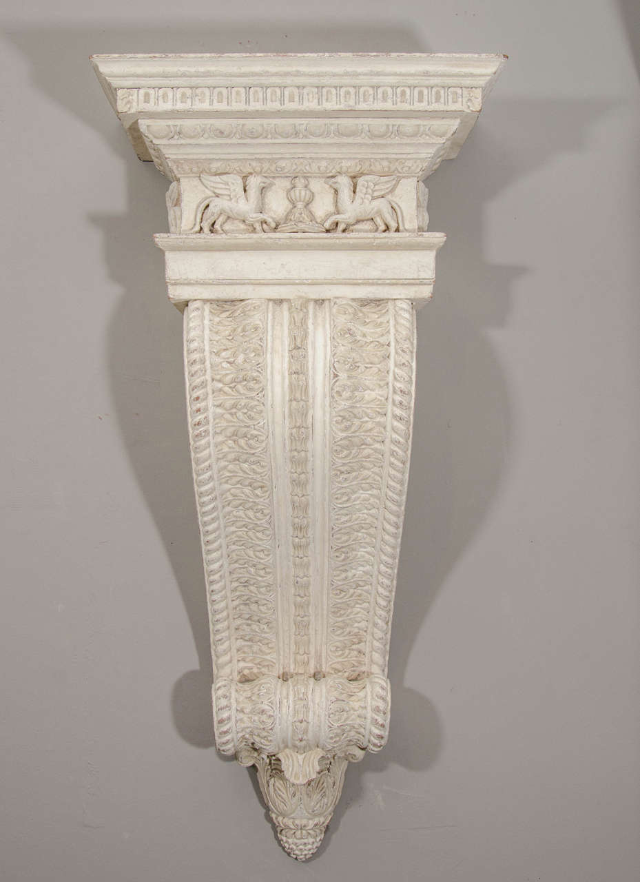 Early 19th century white painted intricated carved wall bracket. Ornamented with griffins.