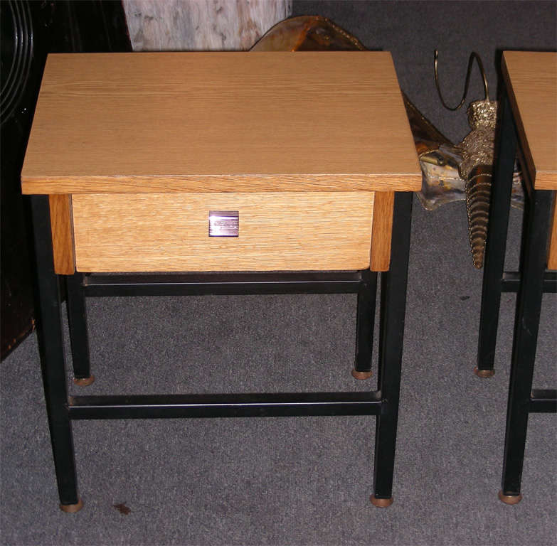 Two 1950s night stands in oak veneer and oak plywood; iron base with legs fitted in gilded brass; one drawer.