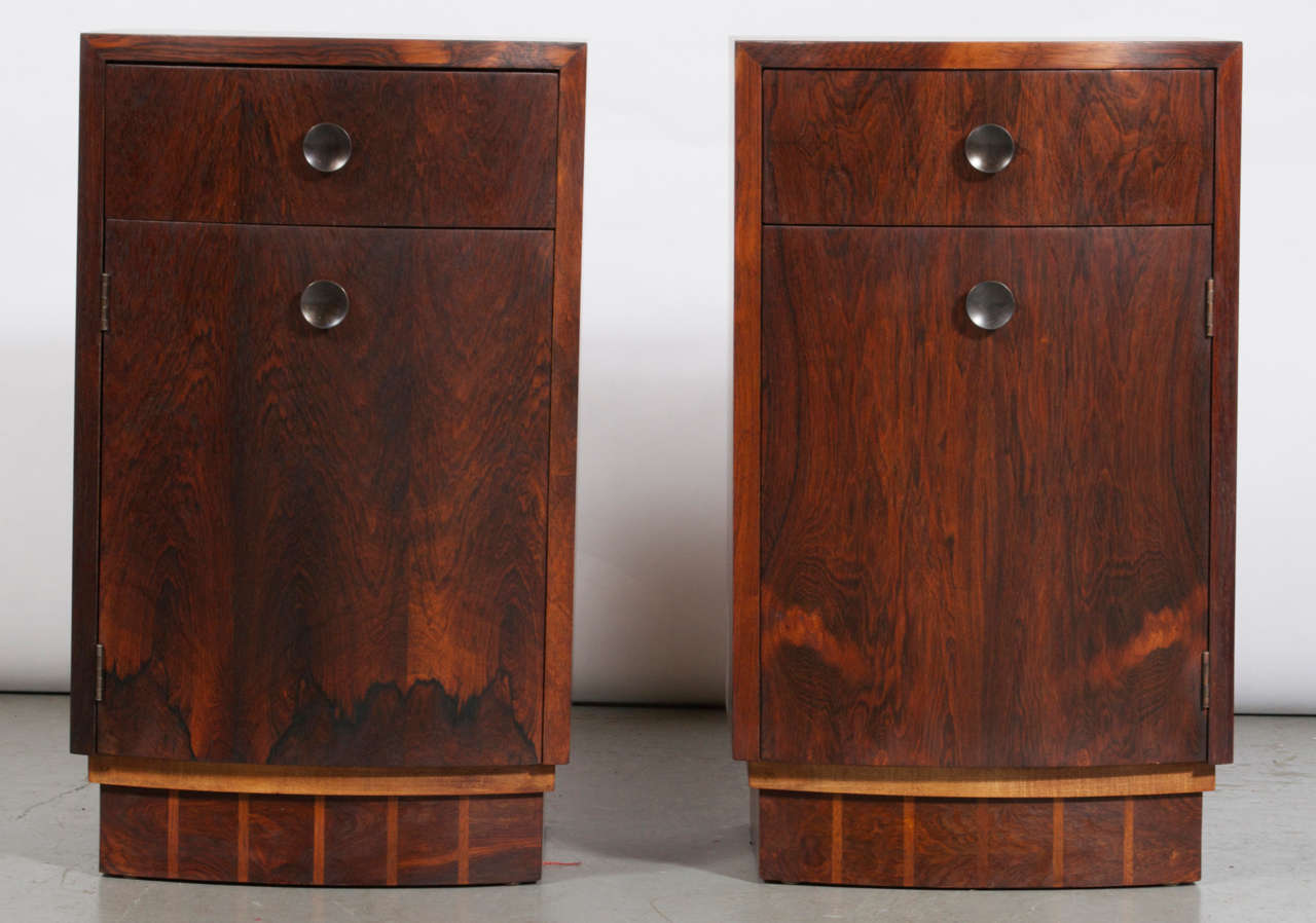 A pair of rosewood Nightstands designed by Gilbert Rhode for Herman Miler. Marked accordingly. Features drawer, and a lower cabinet.