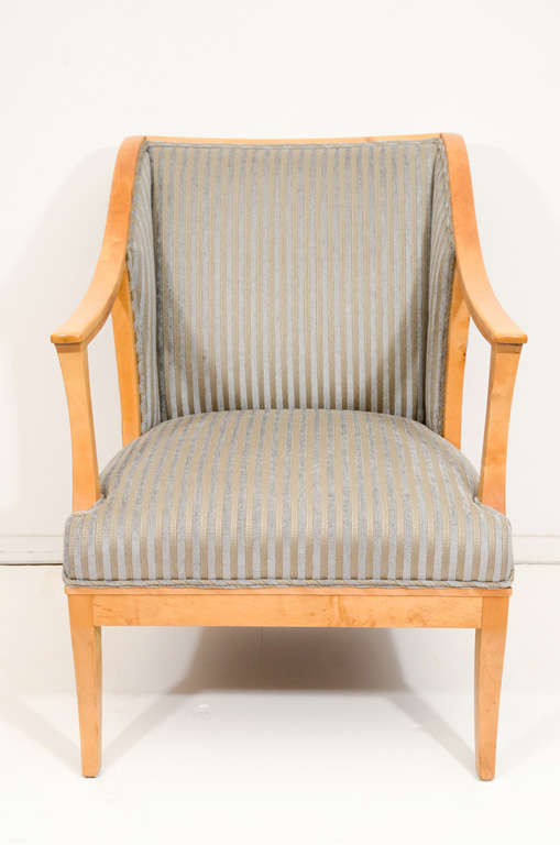 Deep and comfortable, these elegant chairs were designed for a 20th century drawing room. Crafted of solid birch and fir, these sturdy chairs give an air of lightness by Virtue of their open and graceful arms. Recently reupholstered in a period