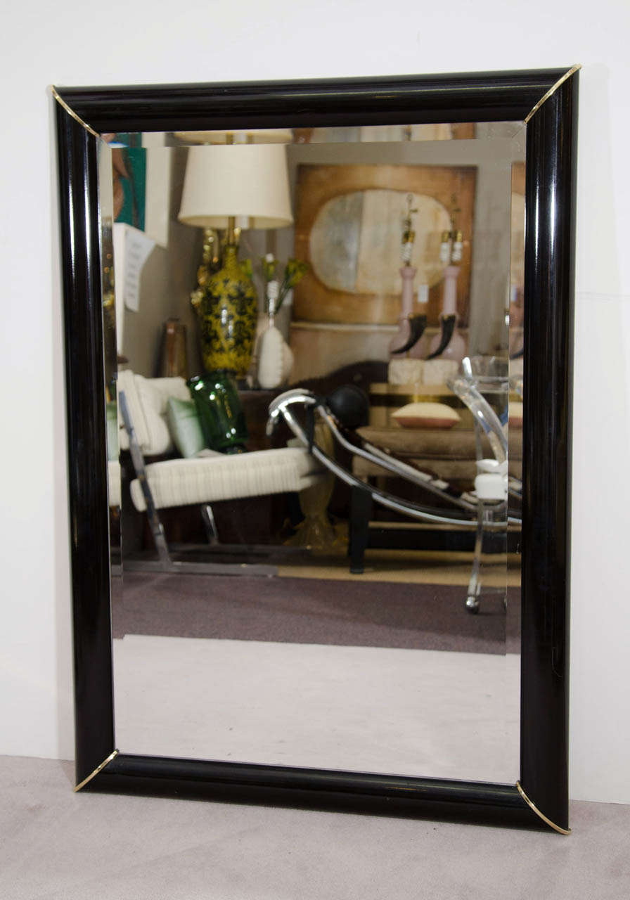A vintage rectangular black lacquered wall mirror with beveled glass and brass corner accents. Circa 1990s. Good vintage condition with age appropriate wear.

Item available here online, or at my showroom space in the Showplace Antique + Design