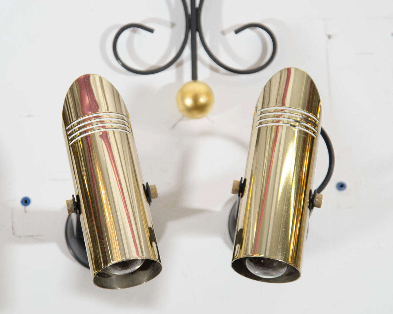 A vintage pair of pivoting spot lights or wall sconces in brass and black enamel.

Good vintage condition with slight scratches to brass and enamel