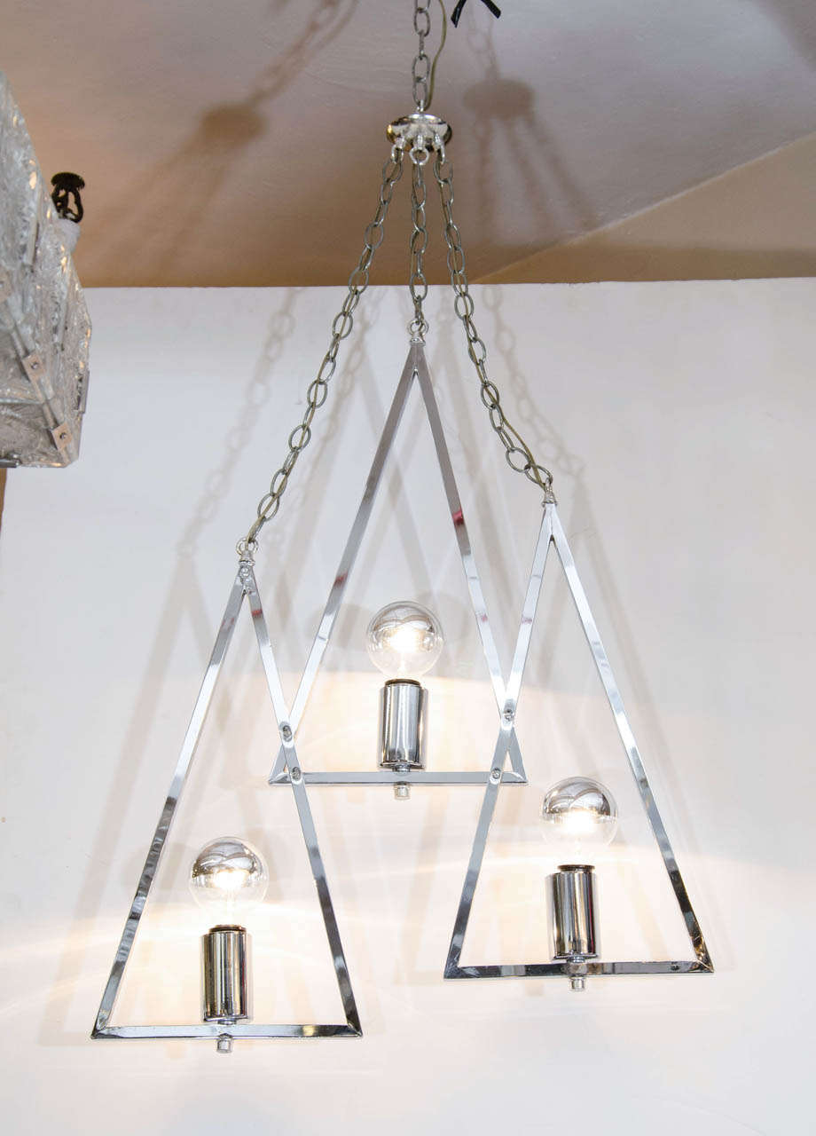 A vintage three-light chandelier comprised of three chrome triangles suspended from chains.

Good vintage condition with age appropriate wear.  Some scratches to the chrome.