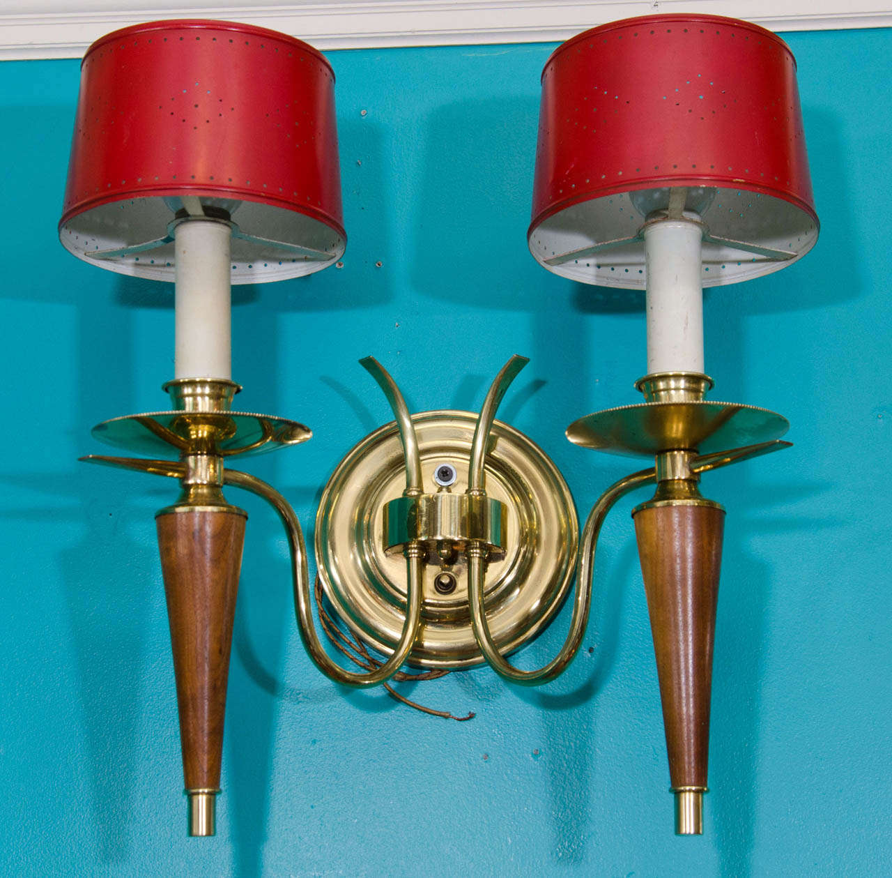 A vintage set of three wood and brass double armed wall sconces with red tole shades.

Good vintage condition with age appropriate wear

Reduced from: $3,750