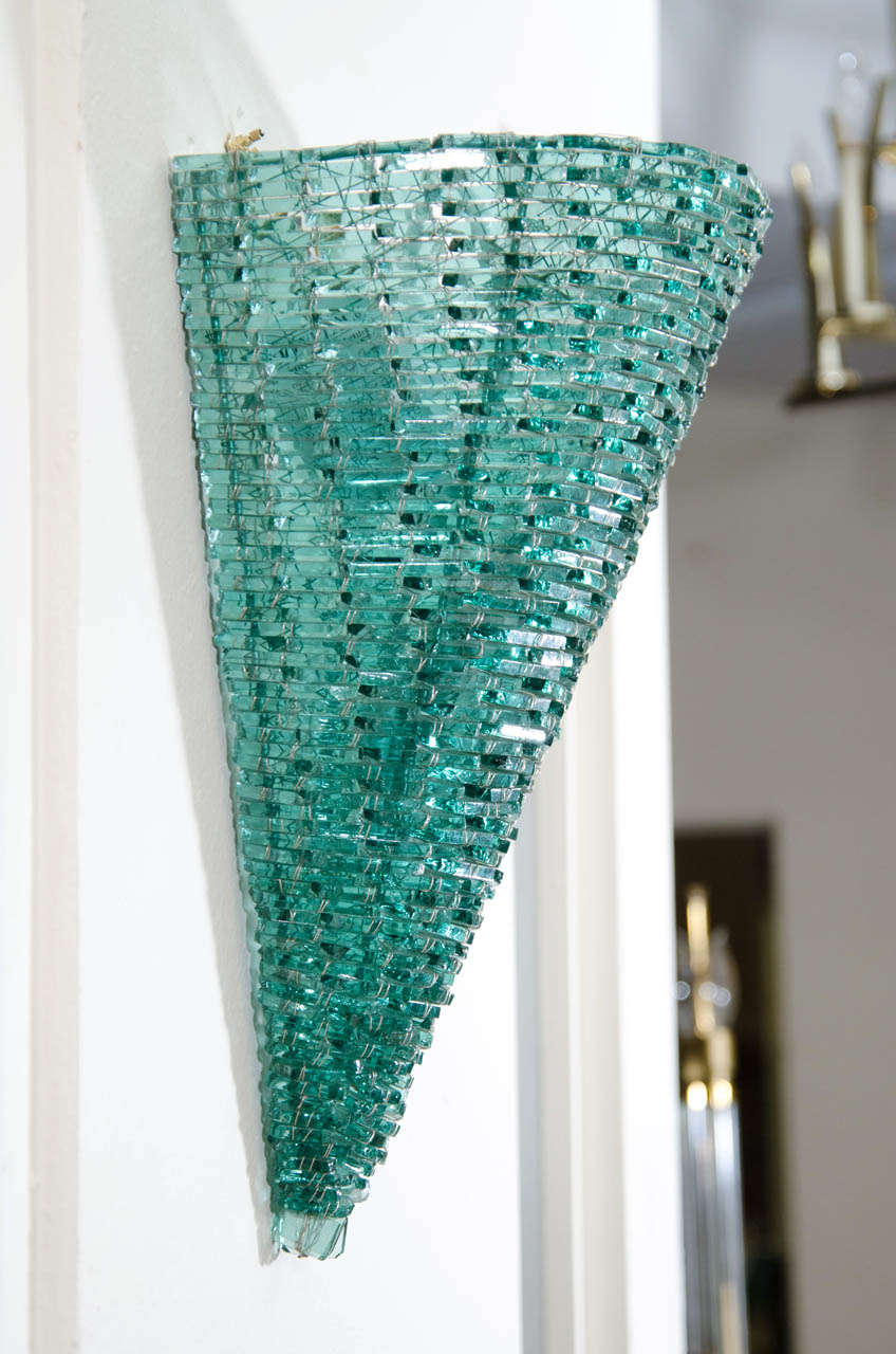 A vintage pair of wall sconces by designer Tony Duquette comprised of tiny green glass chips and metal wire in an inverted cone shape.

Good condition with some jagged edges