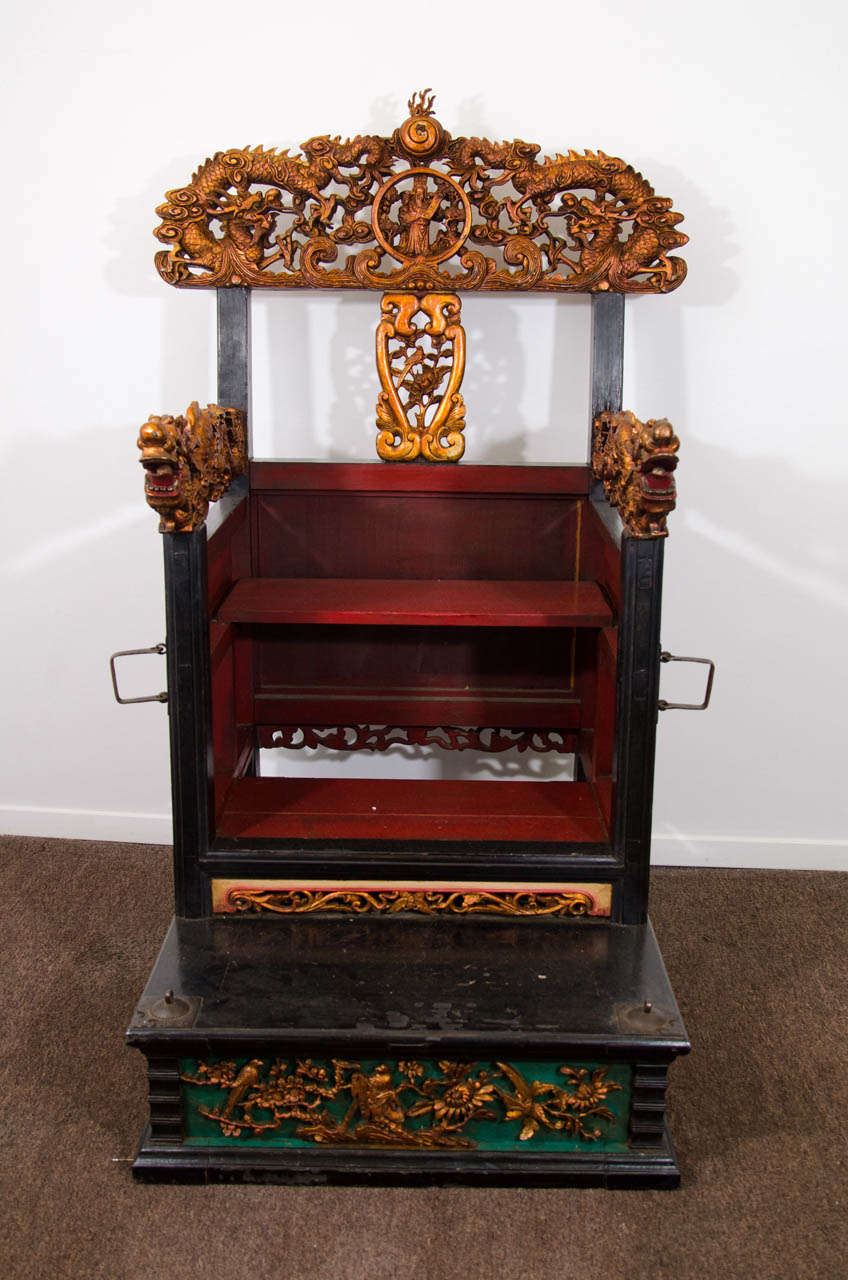 A late 18th century or early 19th century gilt wood Chinese throne chair with intricately carved figures of dragons on the back and arms.  The chair is also decorated with carvings of birds and floral scenes.

Good condition with some spots of