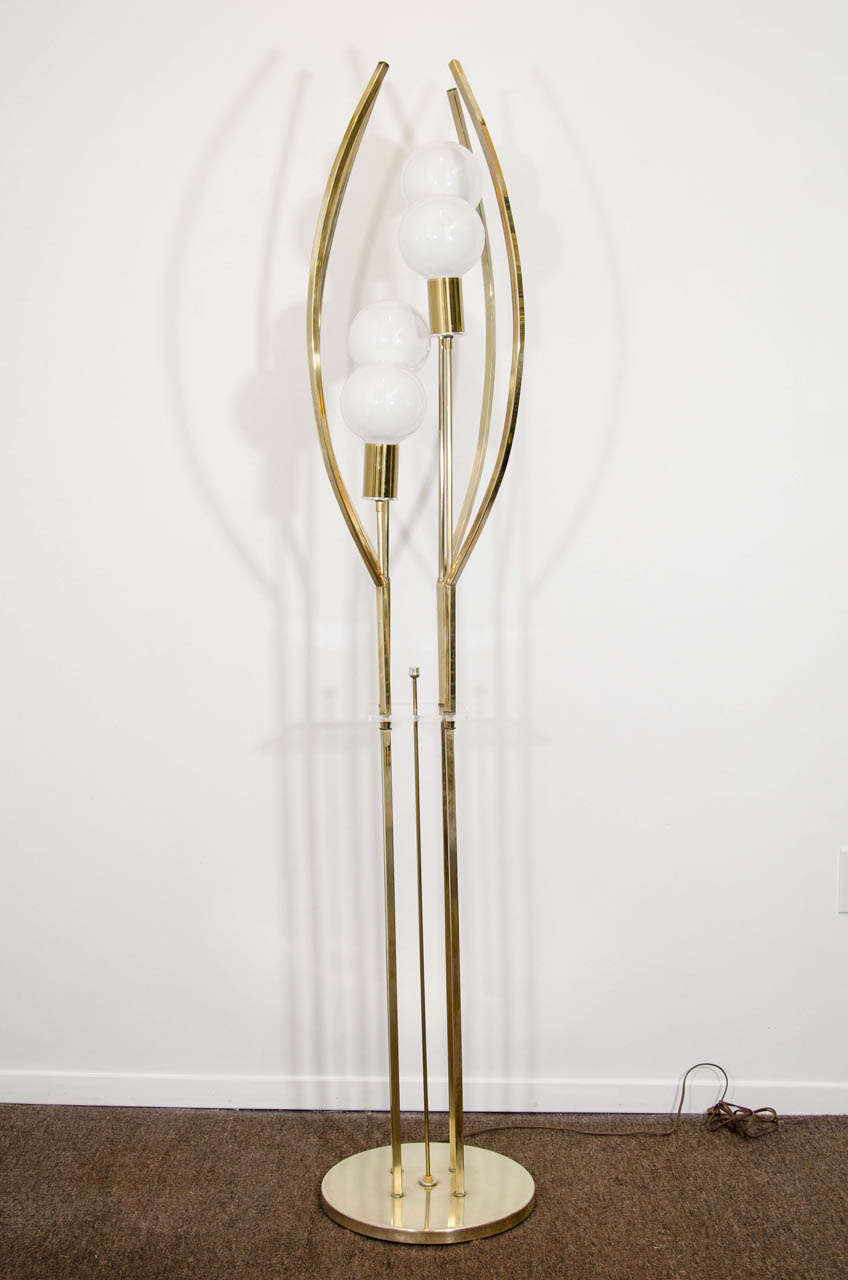 A vintage Lucite and brass tall sculptural four-light  floor lamp.

Good vintage condition with some wear to the brass.