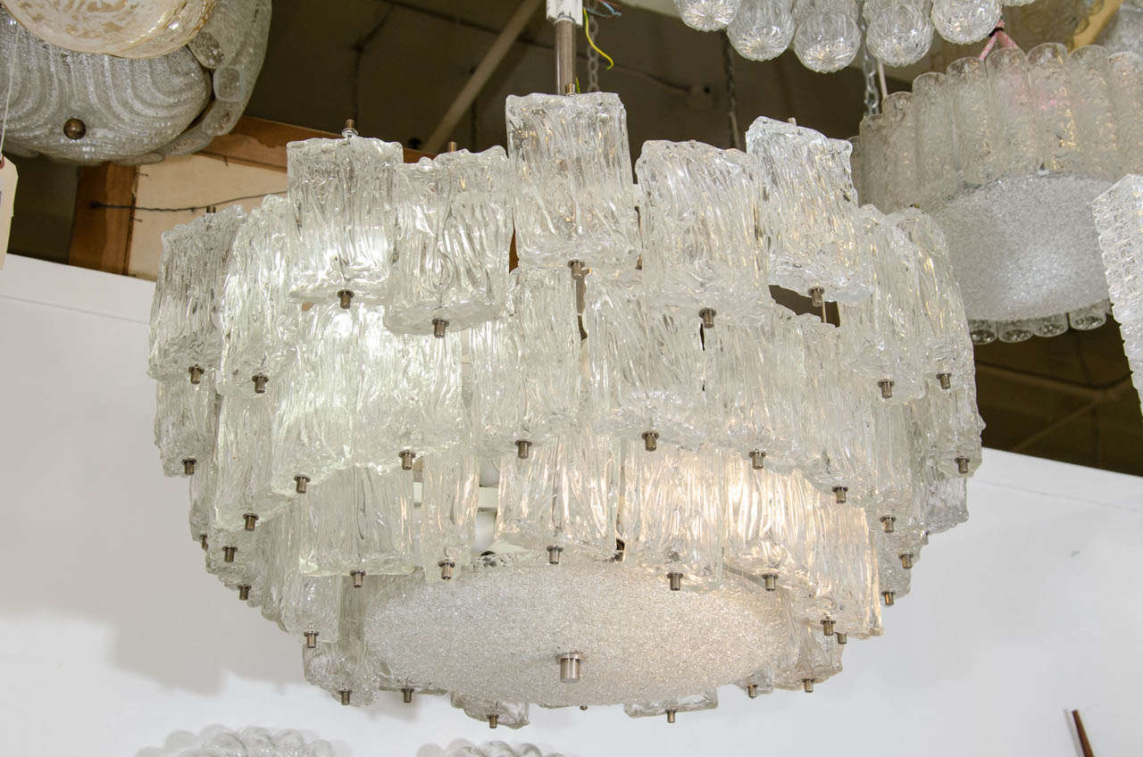 Monumental Barovier & Toso Murano glass chandelier with three-tiers of wavy glass and a silver-toned stem. In good vintage condition having wear consistent with age and use.