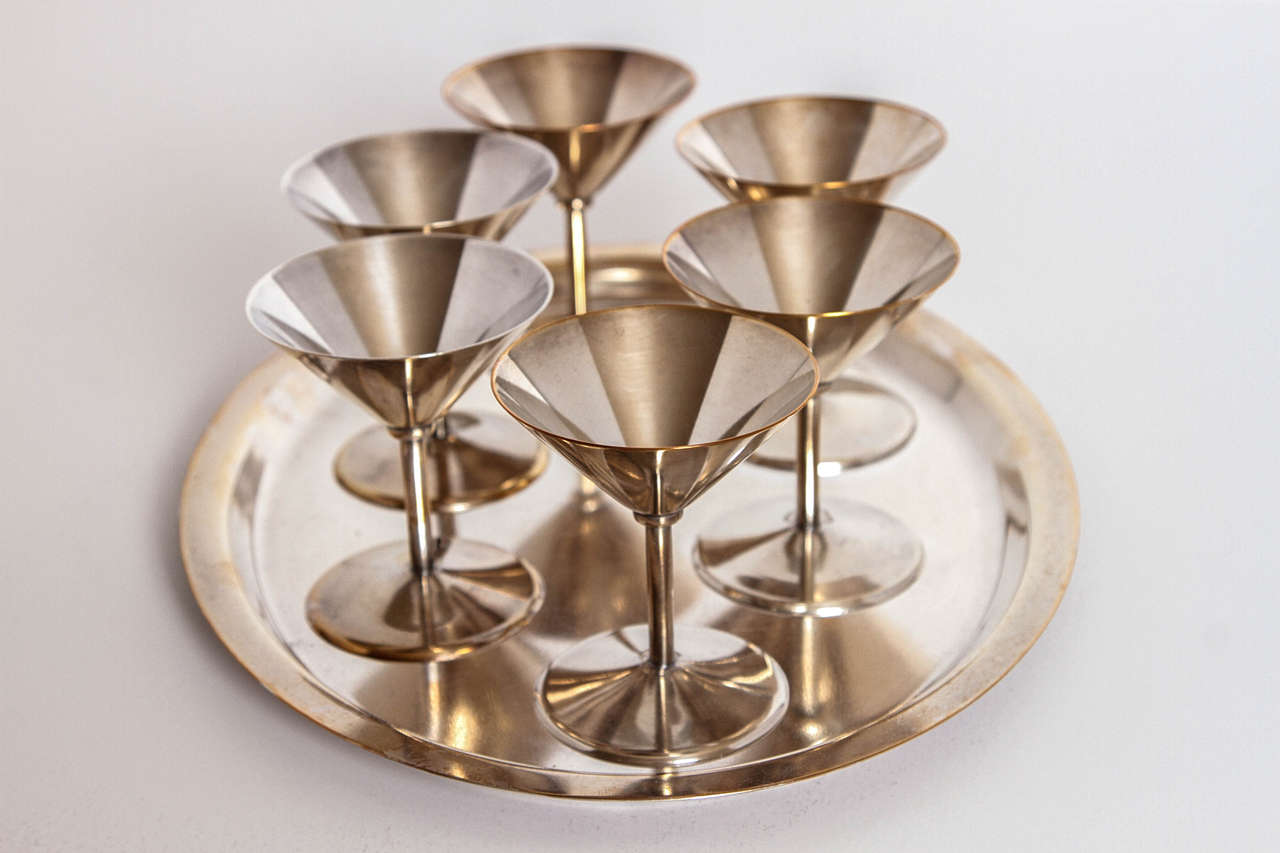 Art Deco silver plate cocktail set by WMF Germany

Very elegant compact Bauhaus influenced set.
Excellent construction quality, with nicely weighted cups.
Six cups and tray. Measures: Cups are 3