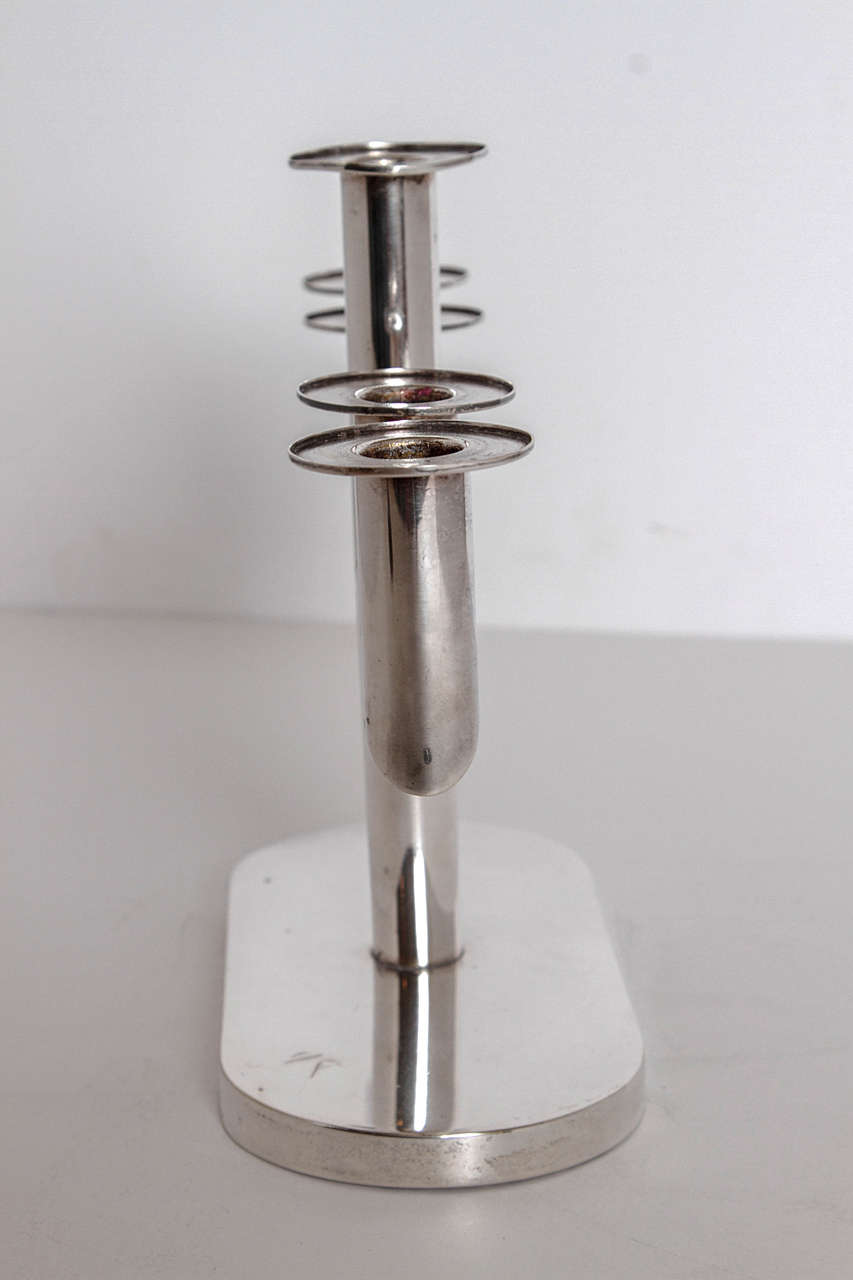 Appealing unsigned tubular five-holder form, similar in construction with Hagenauer and other related European and designs.
Clean Bauhaus machine age look.

Good original condition, minor warbling to center drip catcher. They are removable for
