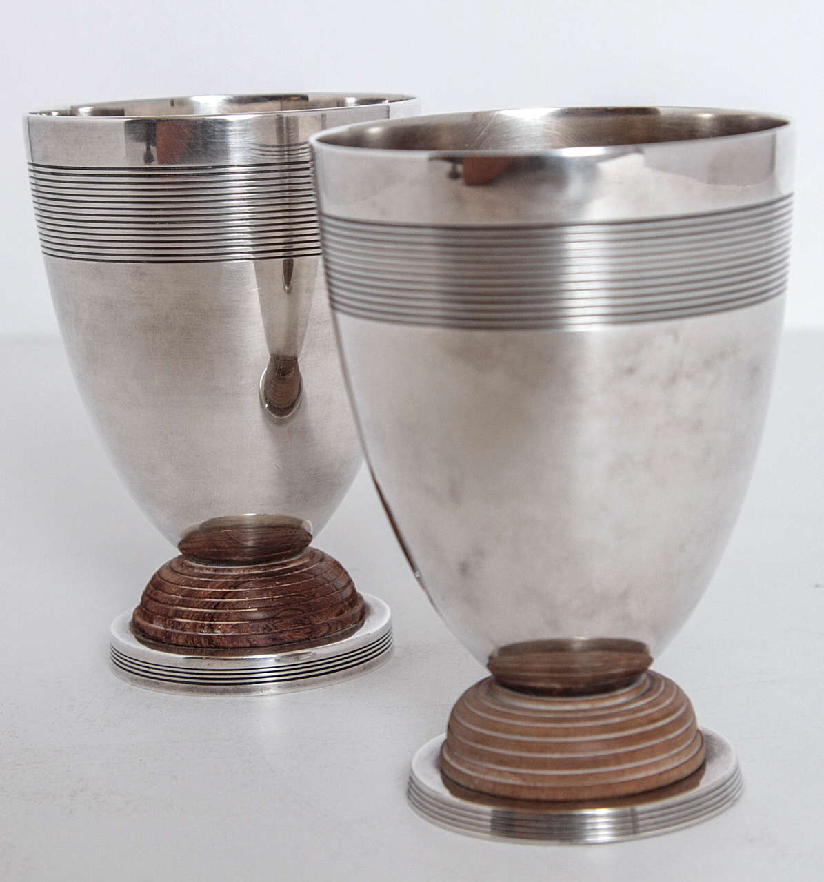 Art Deco Machine Age Christofle Silver Plate Pair Vase Cocktail Cup Goblet 

Nice heft to these, nicely balanced manufacture. 
Christofle signed incised vessels in silver plate and wood.
Hall-marked as pictured.

Very good original condition,