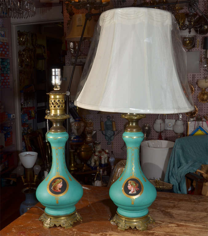 Pair of early Carcel Oil lamps.  Bernard G. Carcel (1750-1818)  designed a lamp to burn thick rape seed oil with the oil reservoir under the burner in the body of the lamp. To keep the oil moving up to the burner, Carcel housed a clockwork mechanism