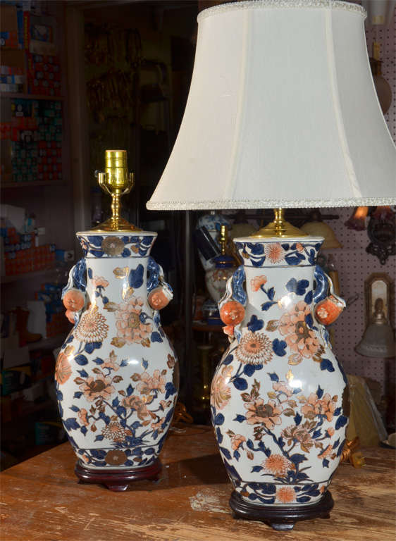Dark to Medium Blue and shades of persimmon Floral Design with applied Pomegranates as handles, Asian Porcelain, mounted on custom bases and wired as Lamps. Priced without shades.  Shade shown is silk oval bell at $165. each. Lamps priced at
