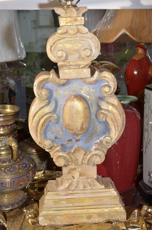 Italian, Hand Carved Wooden Balusters as table lamps, 19th Century with original off white and blue wash with gilt finish.  They have a lovely age related patina.  The lamps are priced as a pair without shades.  Shades shown are oval, flat sided