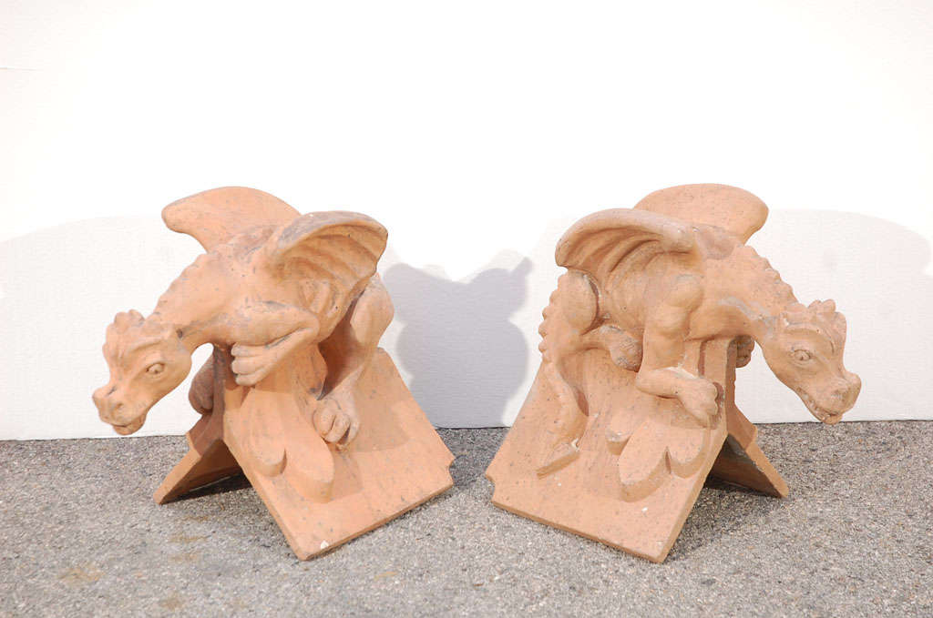 Pair of terracotta, English roof top finials with winged gargoyles. Great condition and color. One small wear hole at the top of one knee. Pari previously priced at $2500.00 now reduced to $1200.00