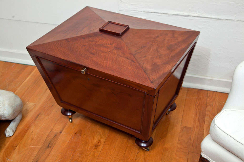 A boldly figured mahogany cellarette on casters with a newly replaced copper liner.
