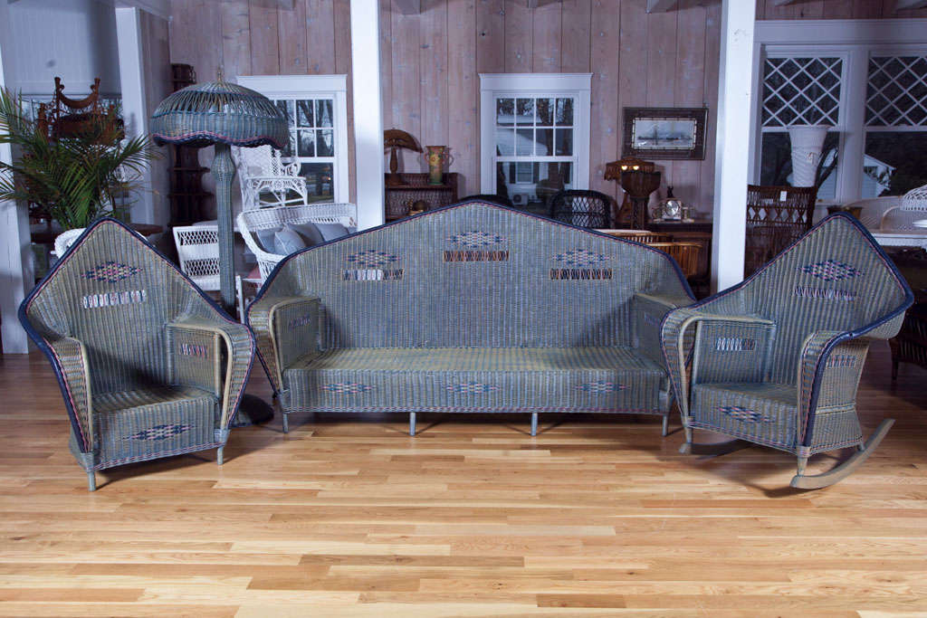 A truly magnificent, one-of-a-kind, wicker set comprised of a sofa, chair, rocker, floor lamp, desk, fernery and sofa table. All pieces have been professionally restored to original condition. A rare find. Antique.

Dimensions:

Sofa: 84