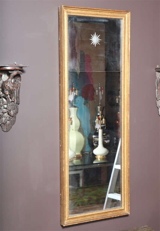 A Continental Neoclassical style Giltwood Mirror