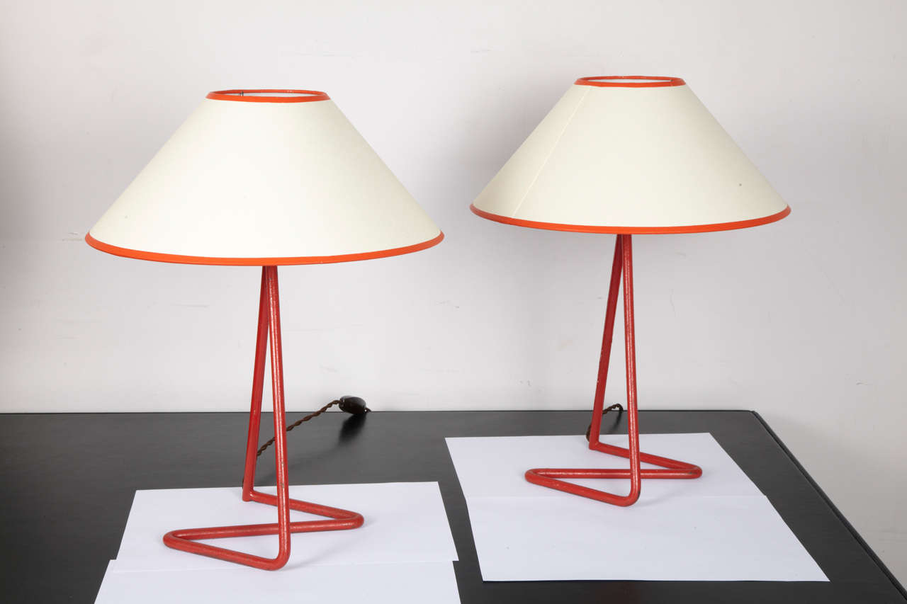 Two lamps by Jean Royère in red lacquered metal and its shade