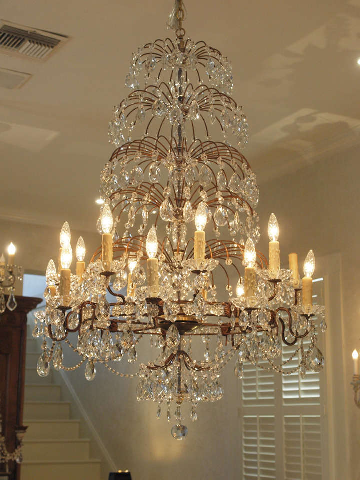 Exquisite early 19th century Italian eighteen-light chandelier with four graceful cascading waterfall tiers of crystals - truly one of a kind.
Restoration: All new US electrical wiring.