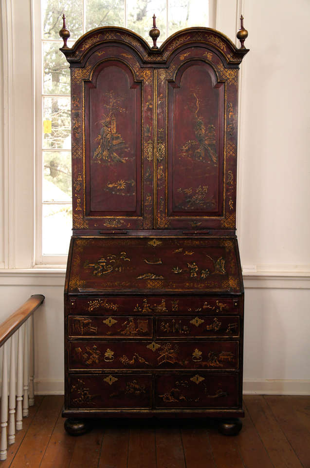 Fine English 18th century red lacquer double-domed bureau bookcase with chinoiserie decoration. The top with later finials over two decorated cabinet doors concealing shelves, pigeon holes and small drawers. The lower section with a slant-lid and