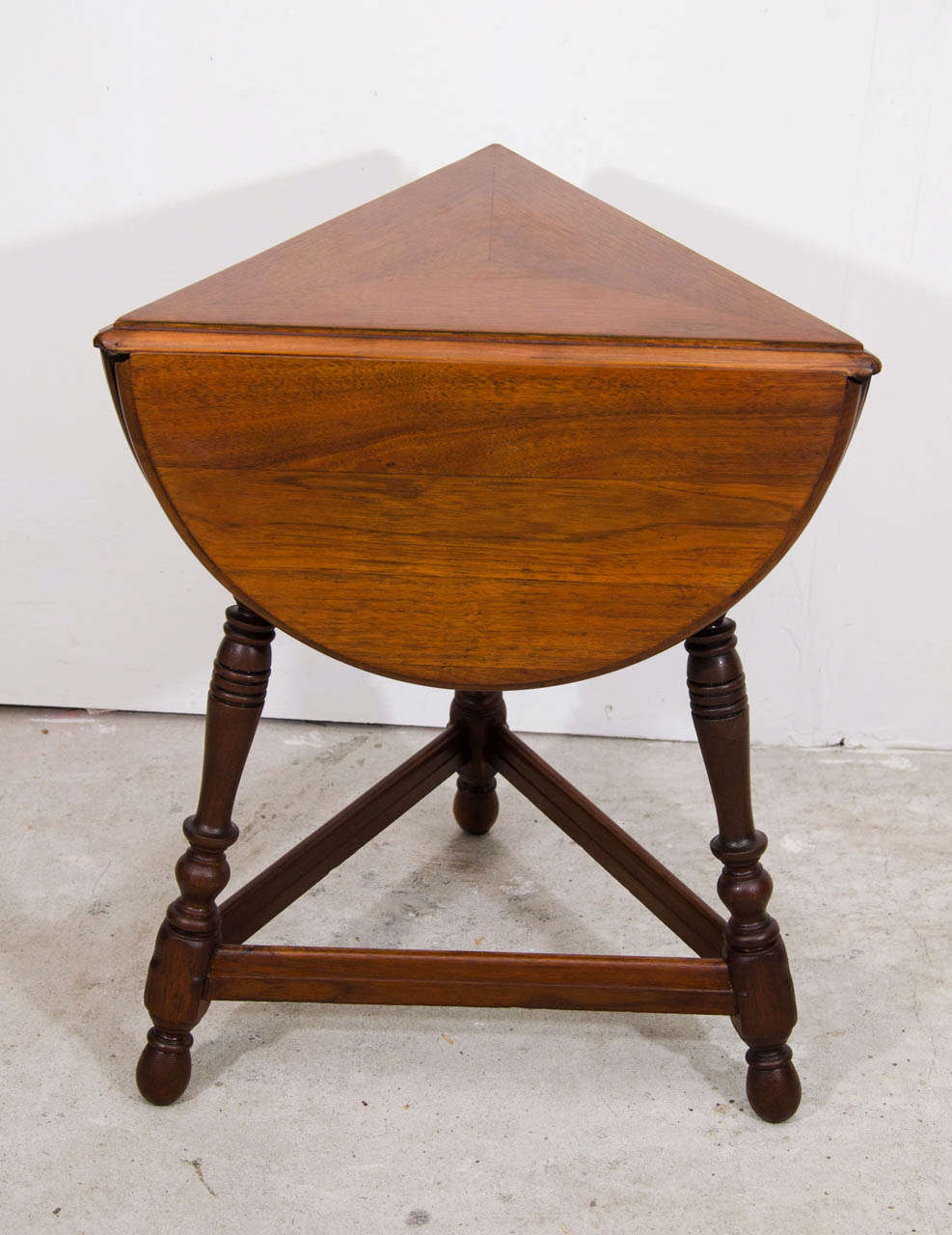 A beautiful early 19th century English solid walnut folding top cricket  table.