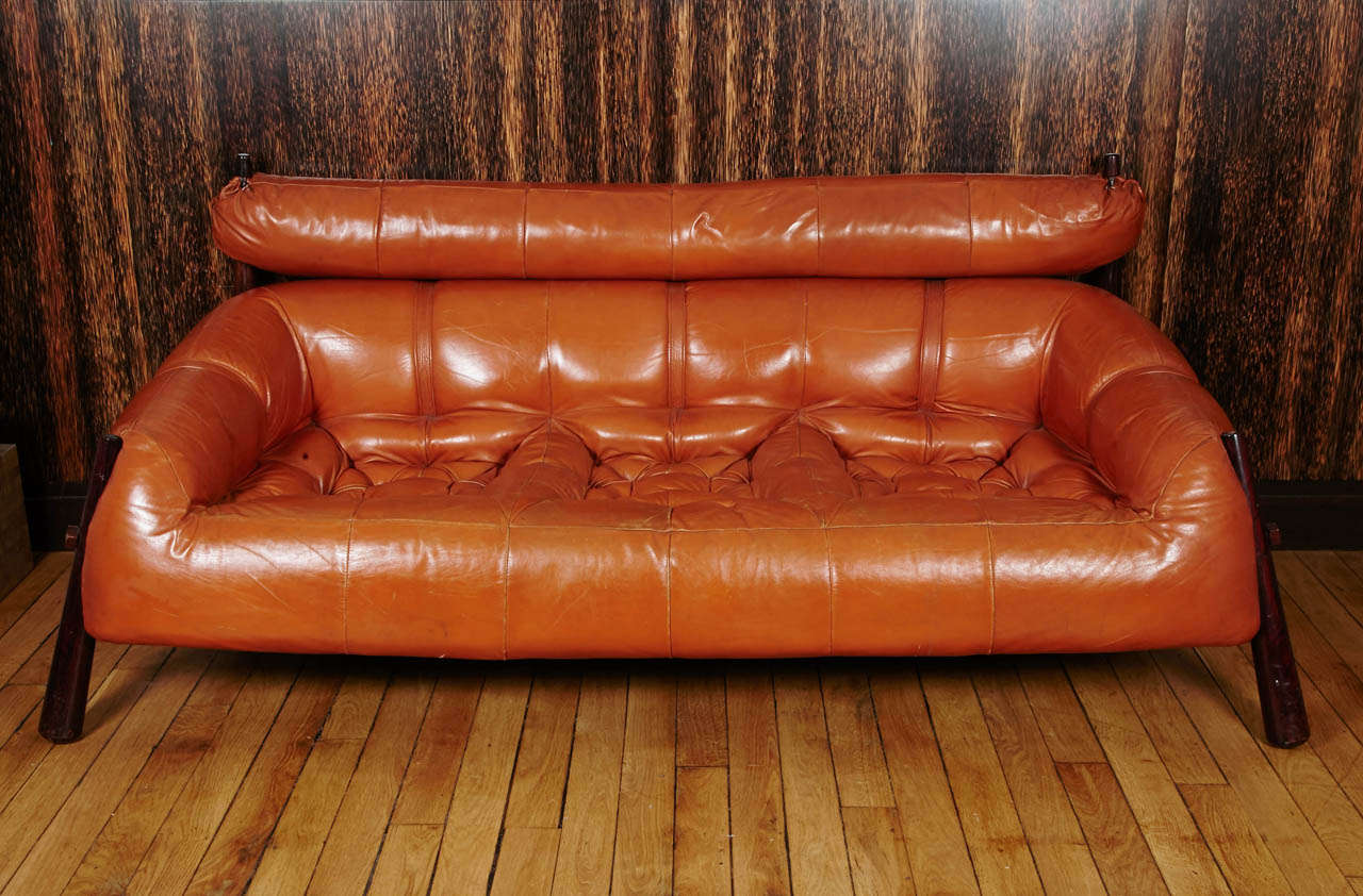A large sofa by Percival LAFER
Produced circa 1970
Gold leather and rosewood
Incredibly comfortable seat