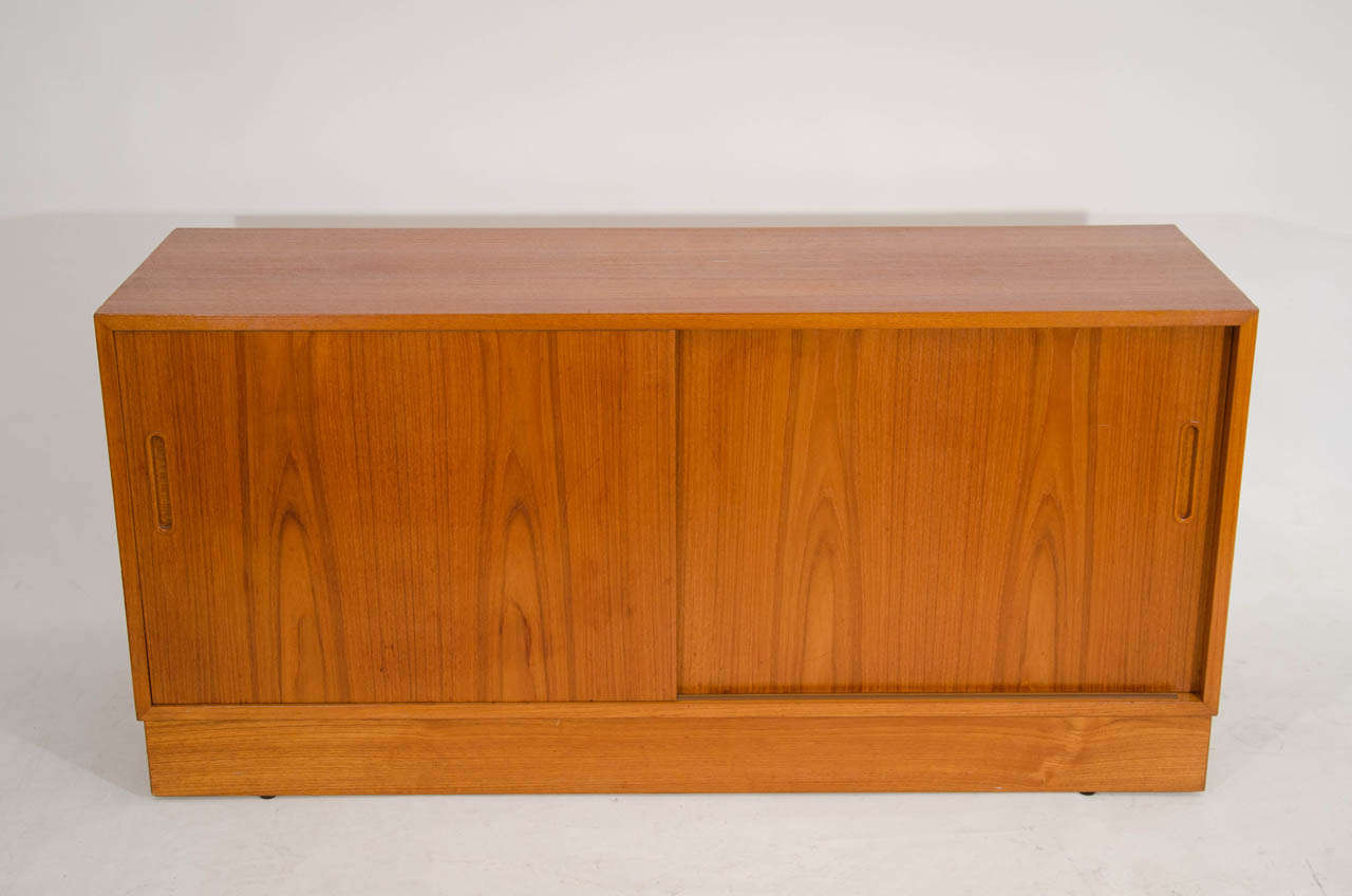 Handsome credenza or cabinet with nice teak graining. The piece is a versatile medium size. Please contact for location. 