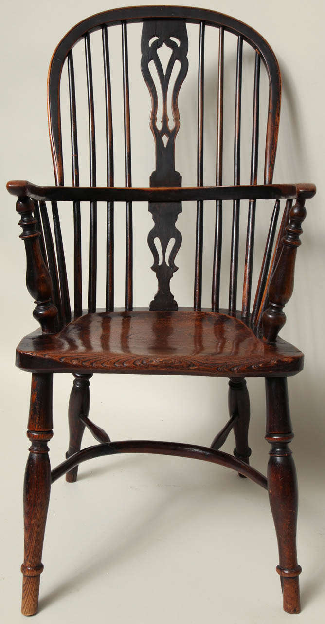 Fine English yew wood and elm windsor hoop back or double bow armchair, the shaped back splat with honeysuckle pattern, the front arm supports with bold turnings over shaped seat, the well turned legs joined by crinoline stretcher, the whole