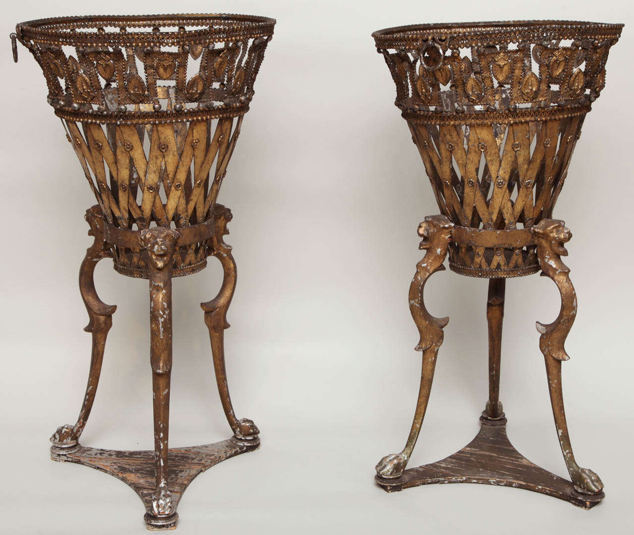 Most unusual pair of Regency tole and wood jardinieres , the removable openwork basket tops with palmette and bead decoration, the iron and wood bases of tripod form, the whole in untouched 