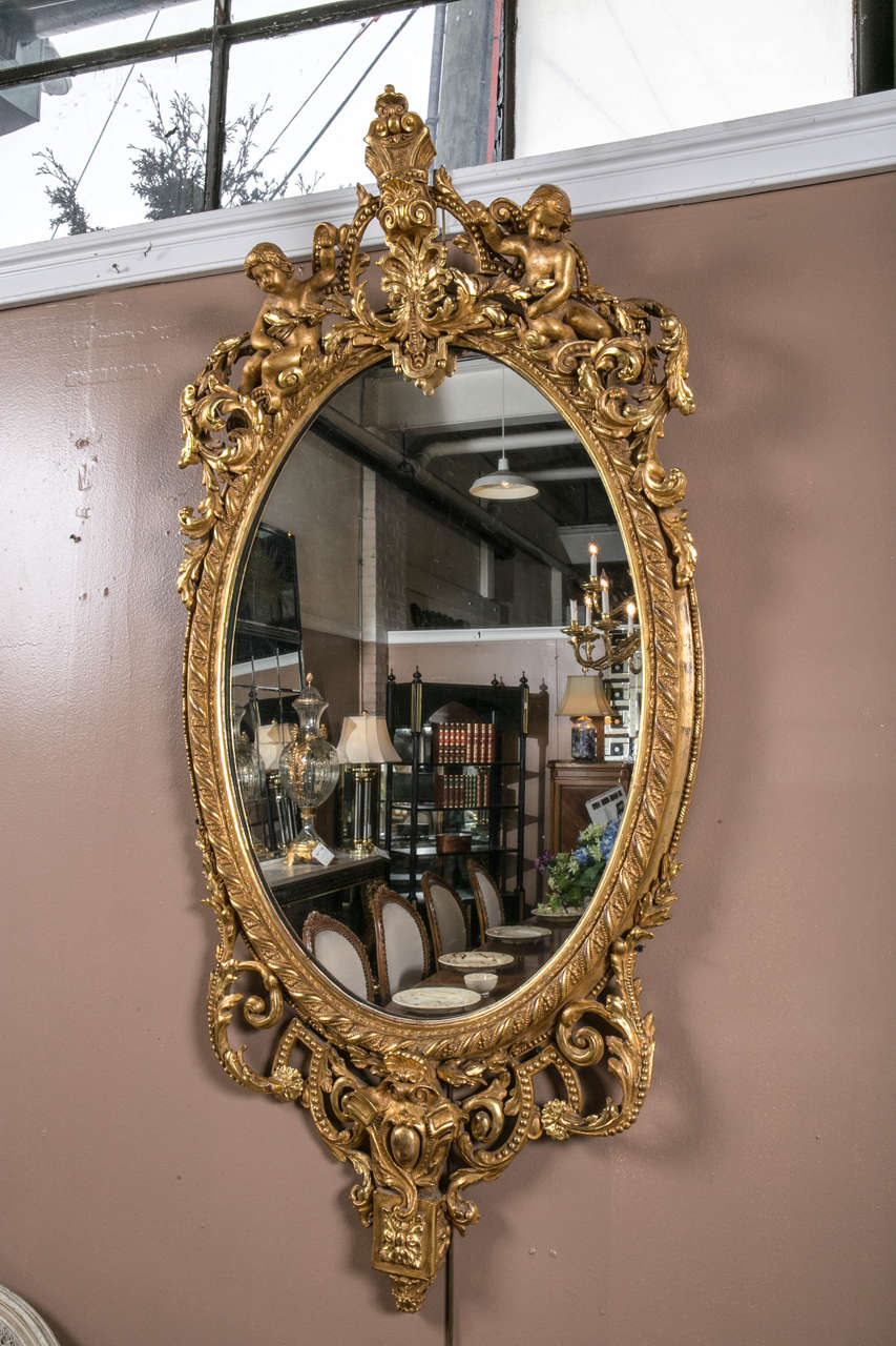 An 18th century or early 19th century palatial Rococo giltwood carved mirror. The finest all-over carved and finely water crest gilt gold mirror in the shop. The bottom and sides having all-over cartouche, leaf, rosettes and vine carved design