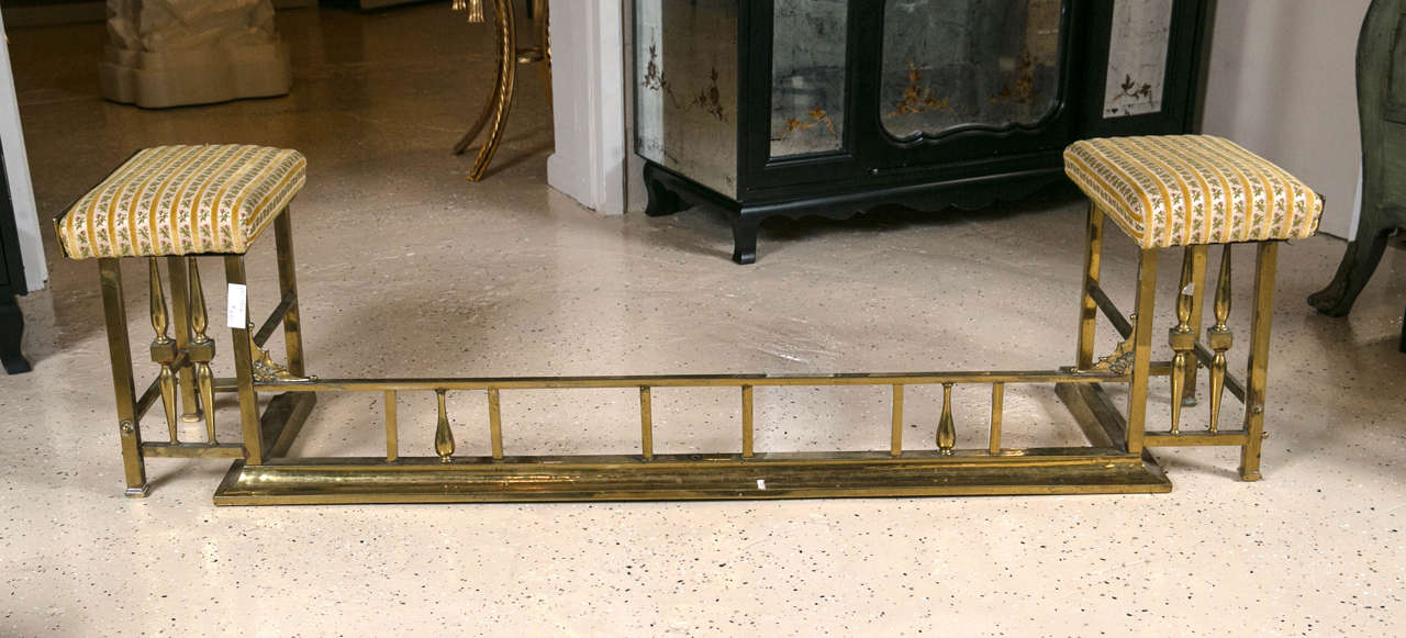 A fine brass fireplace fender with side seats. This brass fender has the typical column form design with rectangular fabric seat tops.

Seat dimensions: 11 X 16.