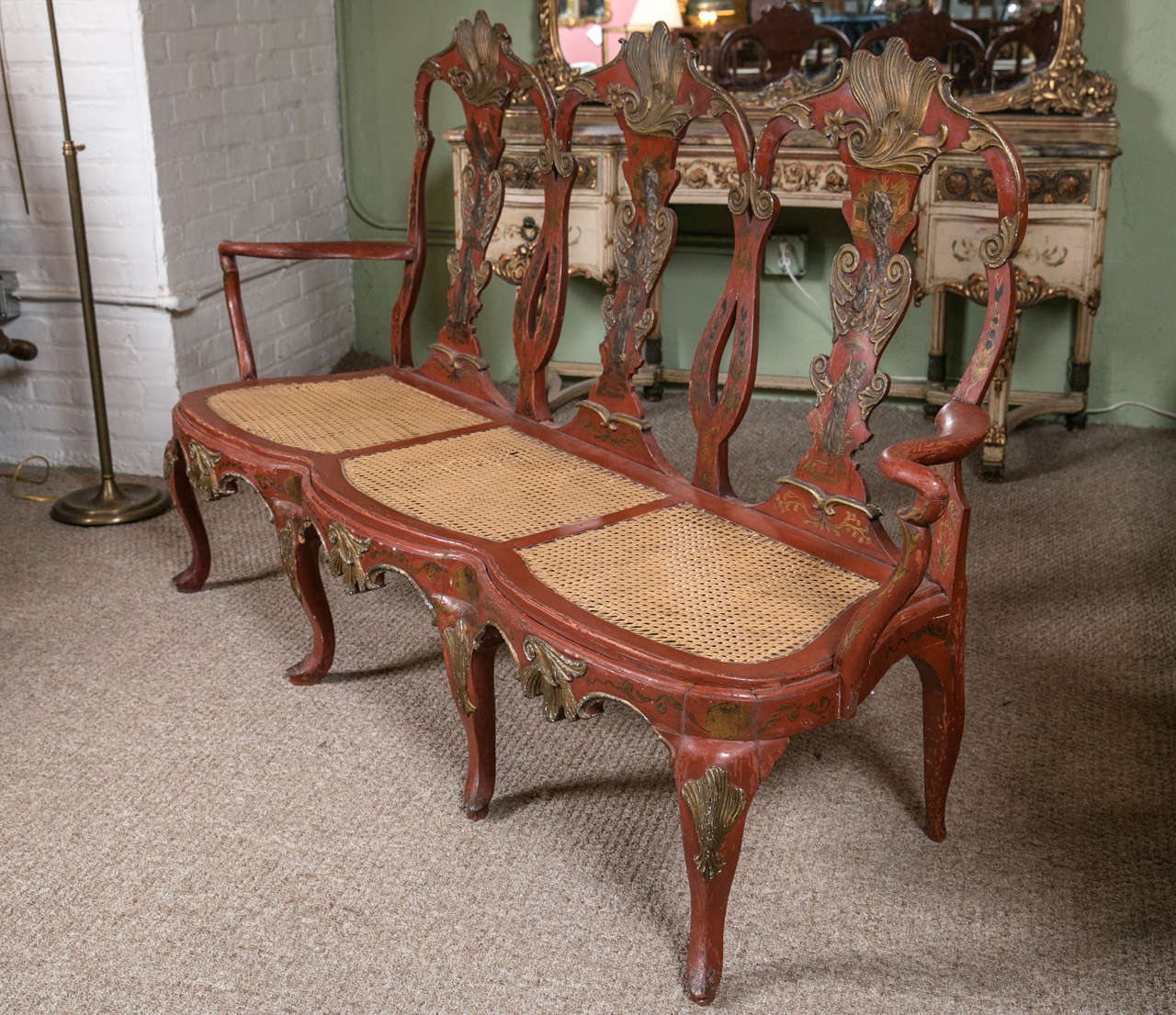 Early 19th century red painted continental bench. This spectacular chinoiserie influenced hall bench or settee has been done in a fine rust paint decorated background with all-over chinoiserie design. The overall structure very well done with fine