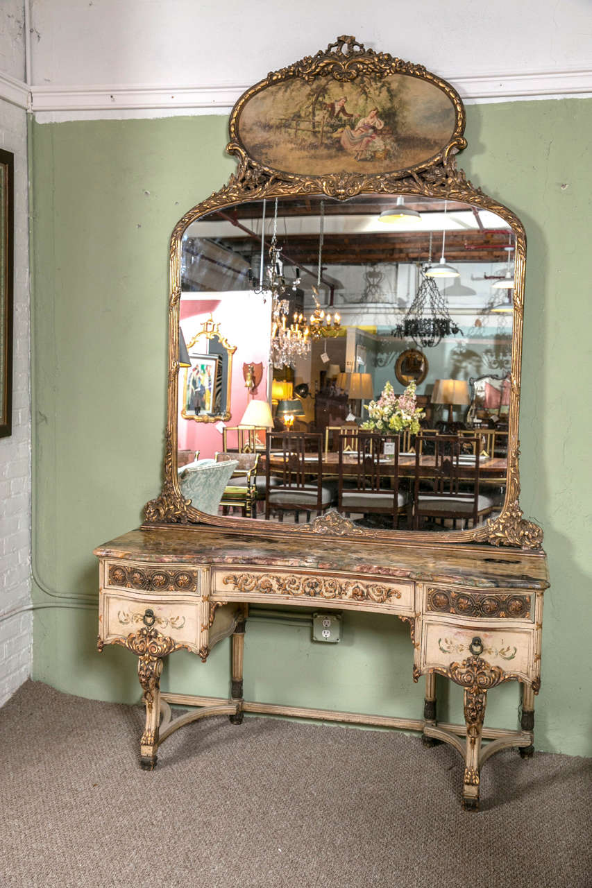 Continental decorated vanity with trumeau mirror. The mirror and vanity sold separately if needed. A fine paint decorated Louis XV style vanity desk having a central drawer flanked by a pair of side drawers all carved in solid wood with paint