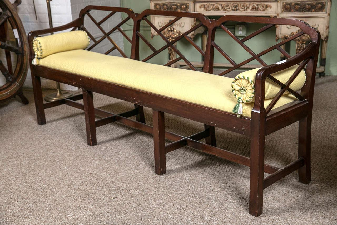 A large English mahogany three / four-seat window or hall bench settee. This splendid mahogany bench or hall seat is manufactured in the Georgian taste. The square legs and undercarriage give wonderful support to the finely upholstered yellow seat