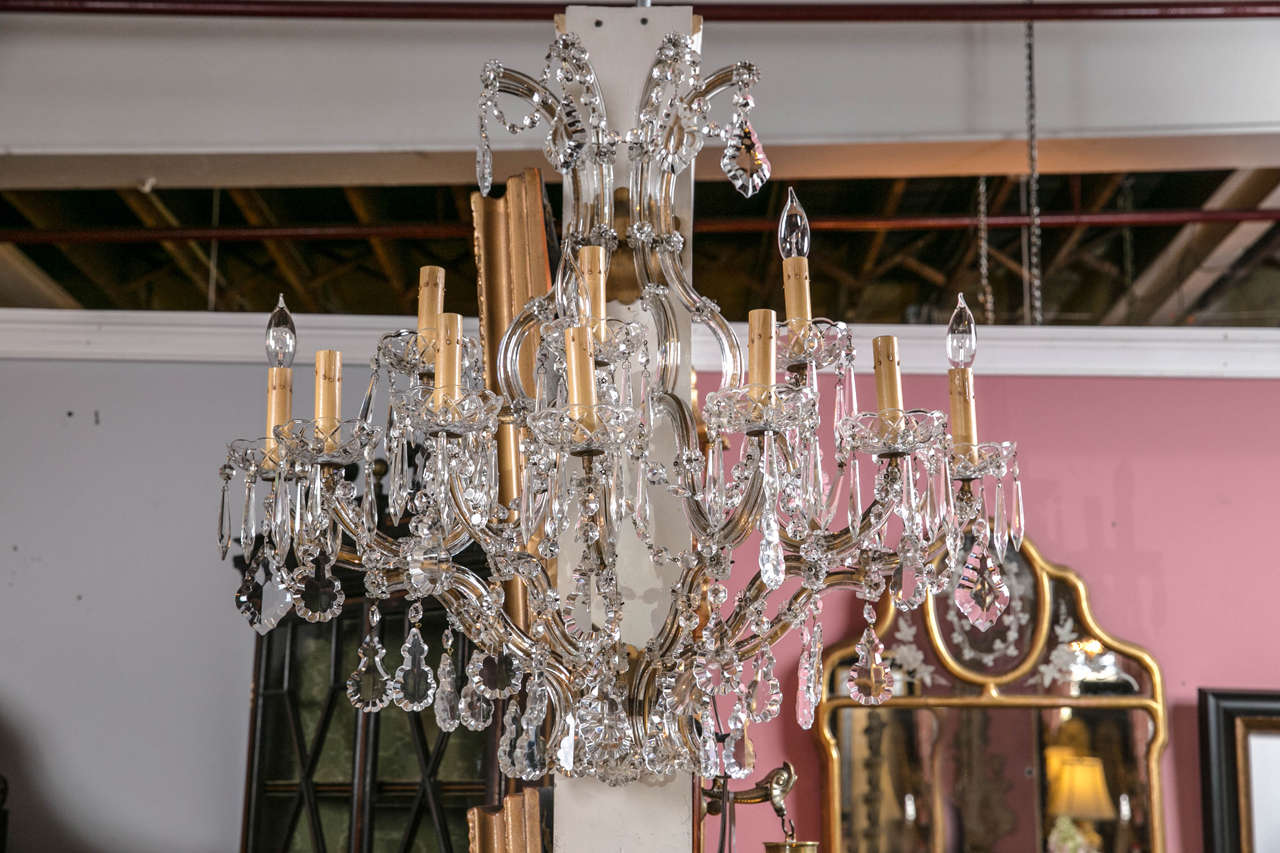 A palatial pair of Venetian crystal wall sconces. Each ten-light sconce having Venetian curved arms flowing onto the candle electrified lights. Both having large hanging crystals. Each recently rewired.