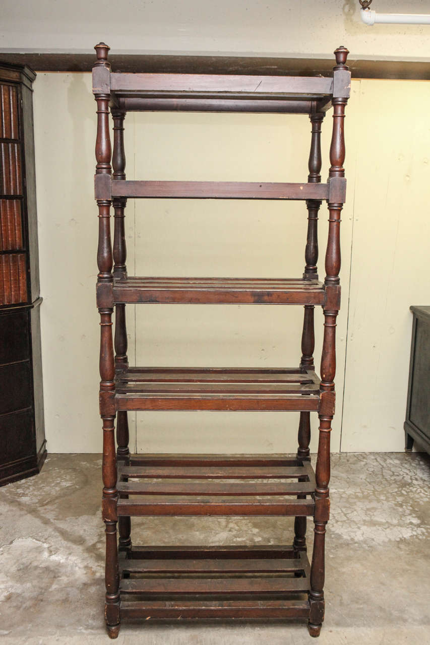 Tall country oak étagère with six slated shelves. Used for storing linens to and displaying books and accessories.