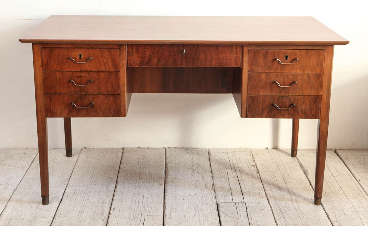 Chic mid-century desk with seven drawers and original brass hardware. Open back for object and book display.