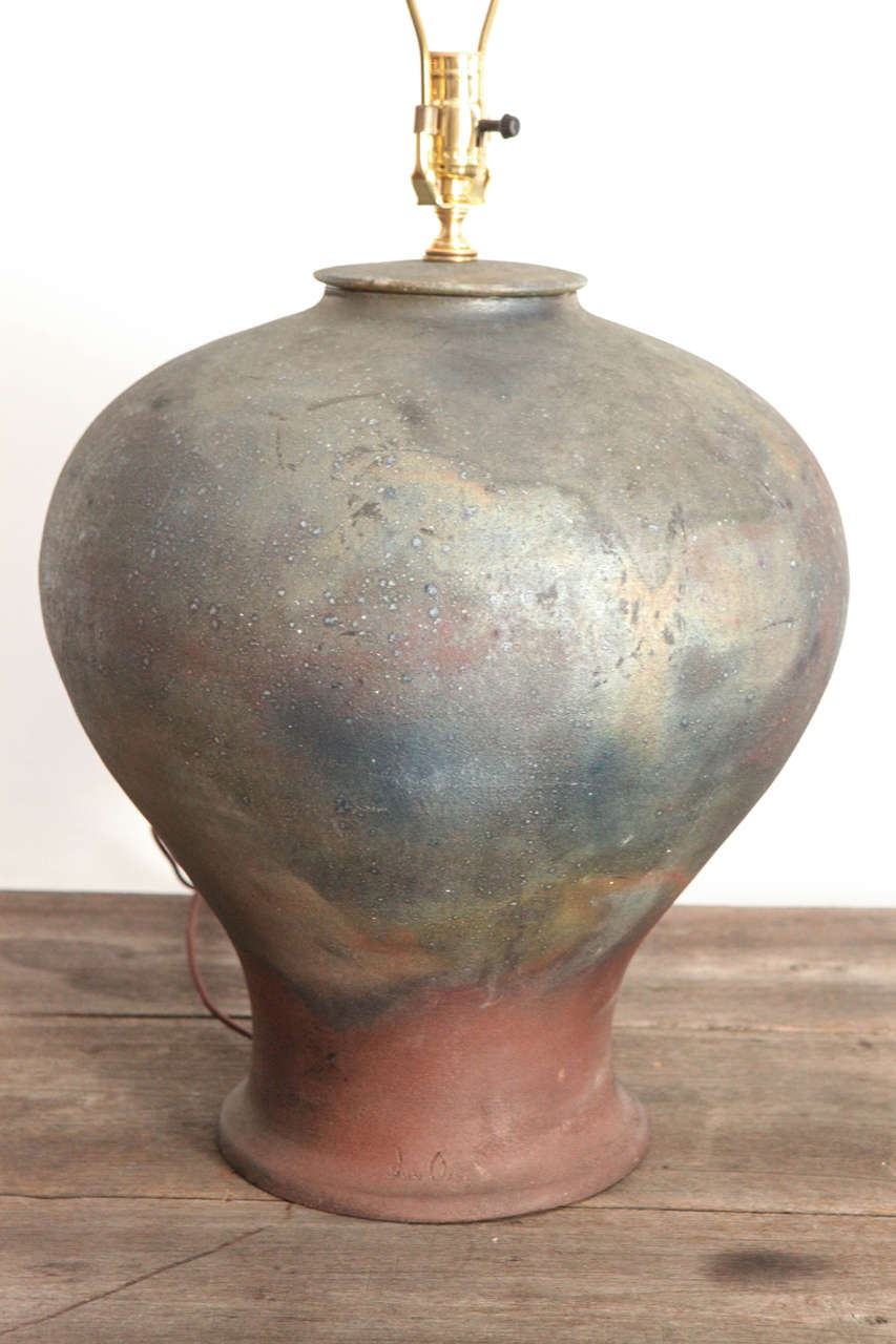 Ceramic urn table lamp with patina of rustic iron and copper glaze finish. Shade not included. Measures 17