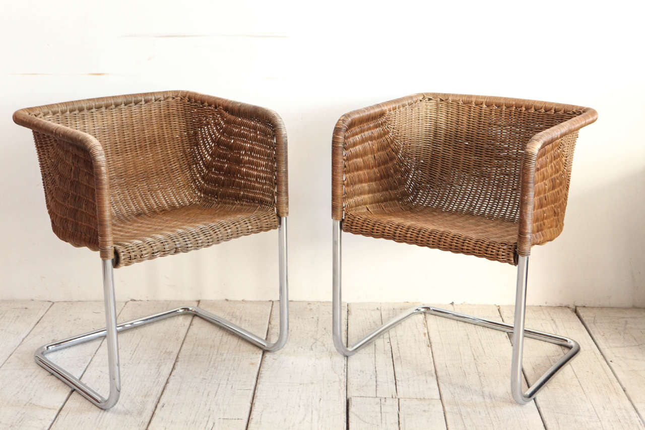 Set of four wicker dining chairs with tubular chrome frames by Harvey Probber.